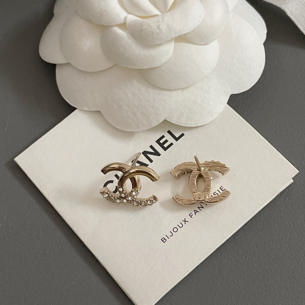 Gold-tone CC hoop and bar earrings with rhinestone details on jewelry card