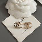 Gold-tone CC hoop and bar earrings with rhinestone details on jewelry card