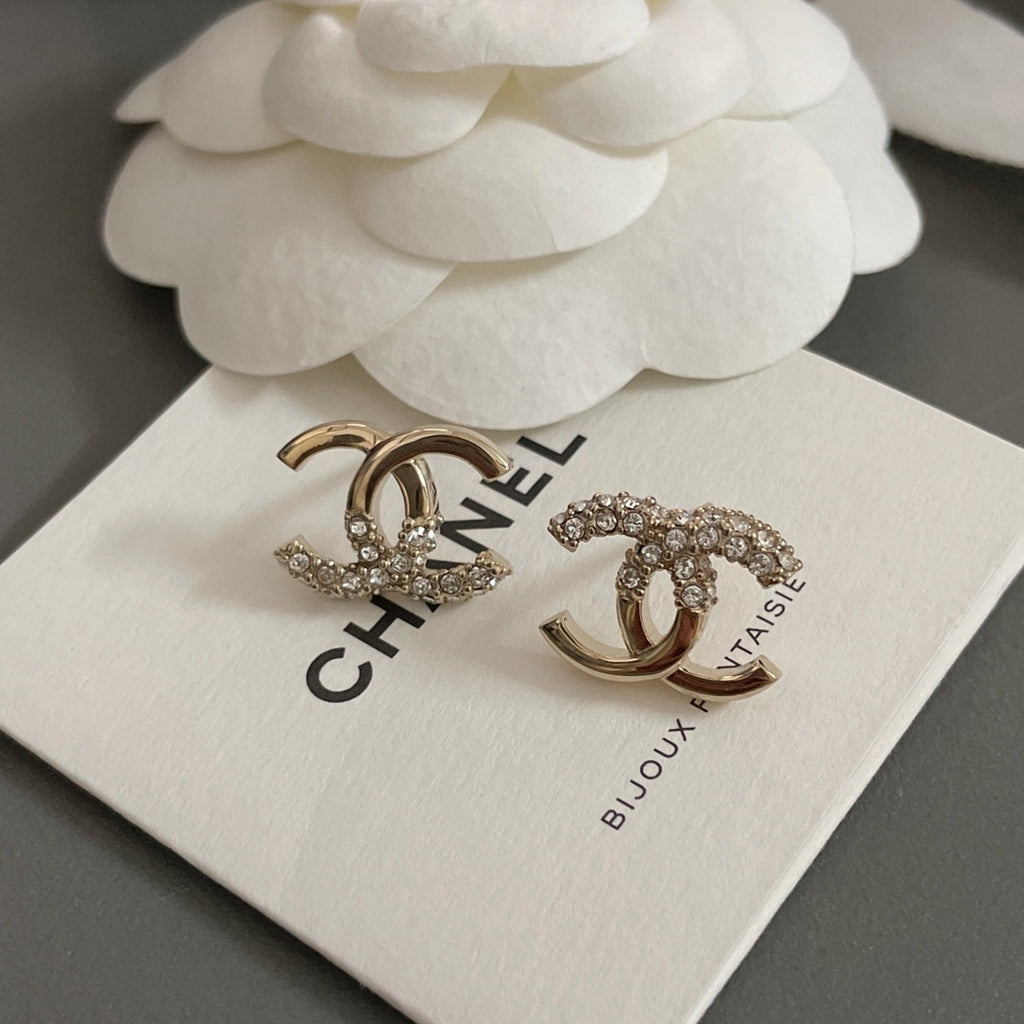 Gold-tone CC hoop and stud earrings with rhinestones on jewelry card