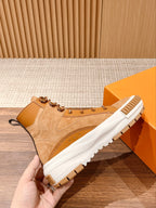 Louis Vuitton tan suede high-top sneaker with padded collar, lace-up front, and white sole