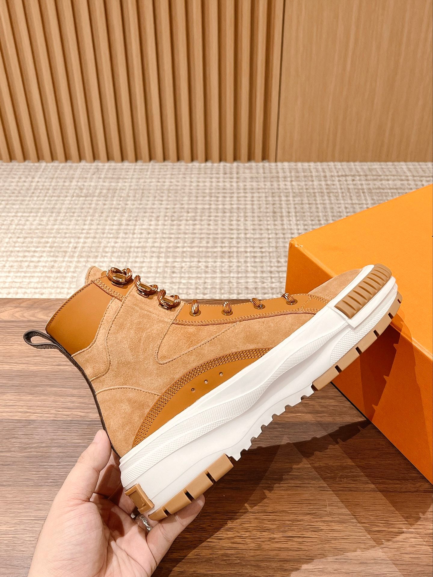 Louis Vuitton tan suede high-top sneaker with padded collar, lace-up front, and white sole