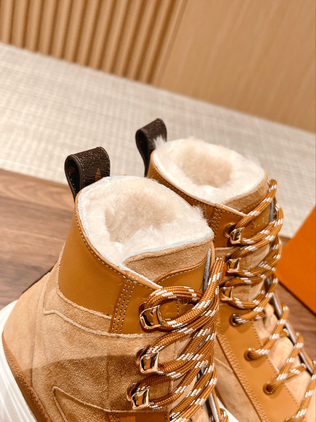 Louis Vuitton tan suede high-top sneakers with fur-lined tongue, gold laces, and white sole