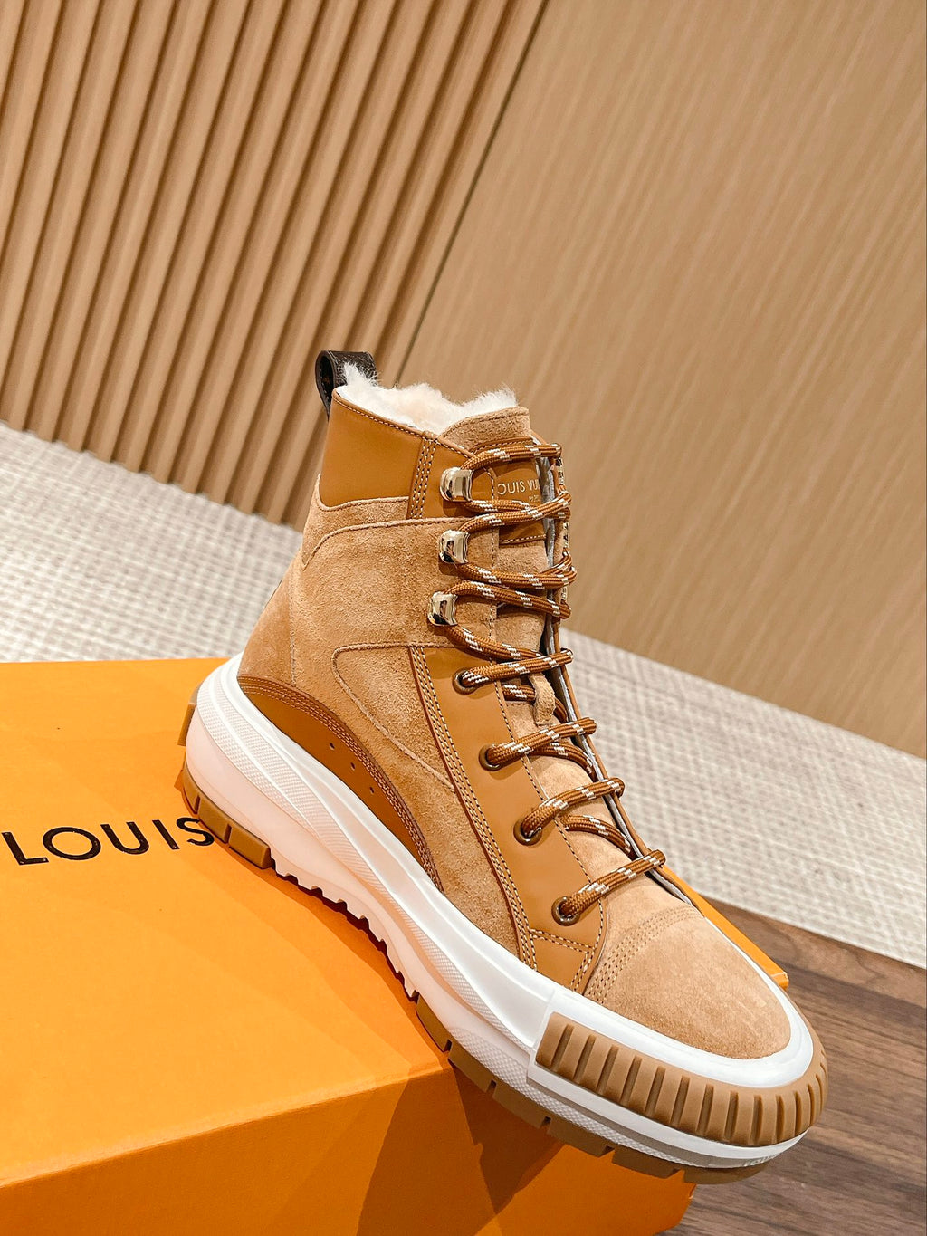 Louis Vuitton tan suede high-top sneaker with fur-lined collar, laces, and white sole