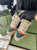 Pair of Gucci unisex sneakers in light beige with green and orange logo panels