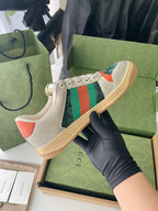 Gucci unisex sneakers in light beige with green stripe and orange heel accents