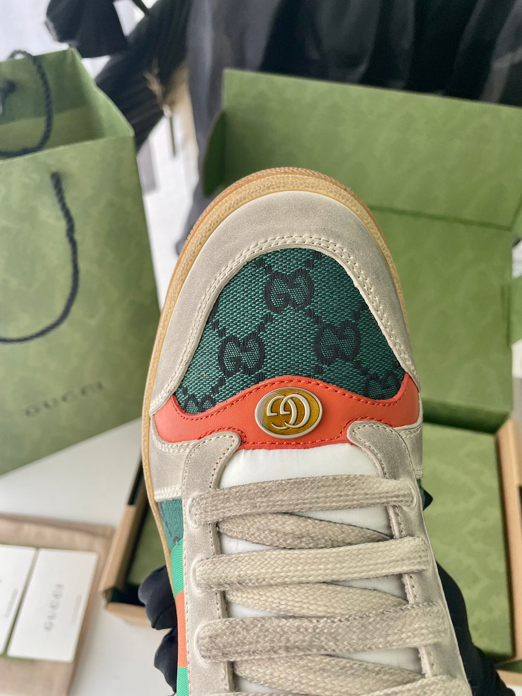 Gucci unisex sneaker toe with green monogram pattern and orange trim