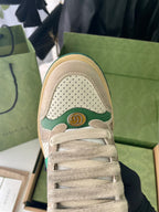 Gucci unisex sneaker close-up, perforated beige toe with green crest emblem