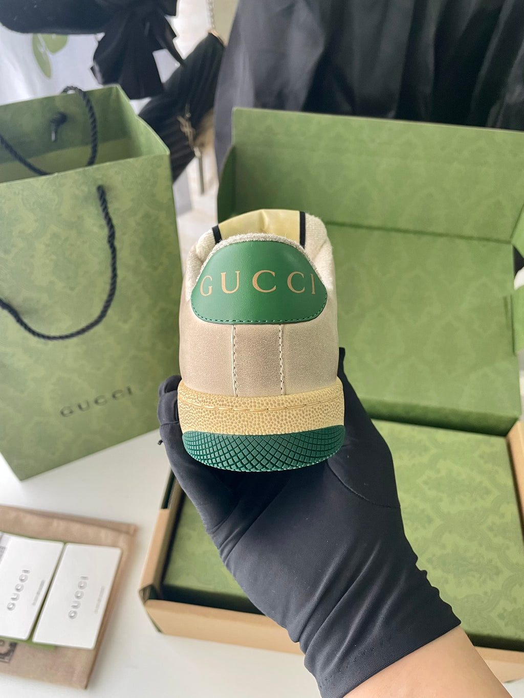 Gucci unisex sneaker, beige heel with green Gucci label and textured outsole edge