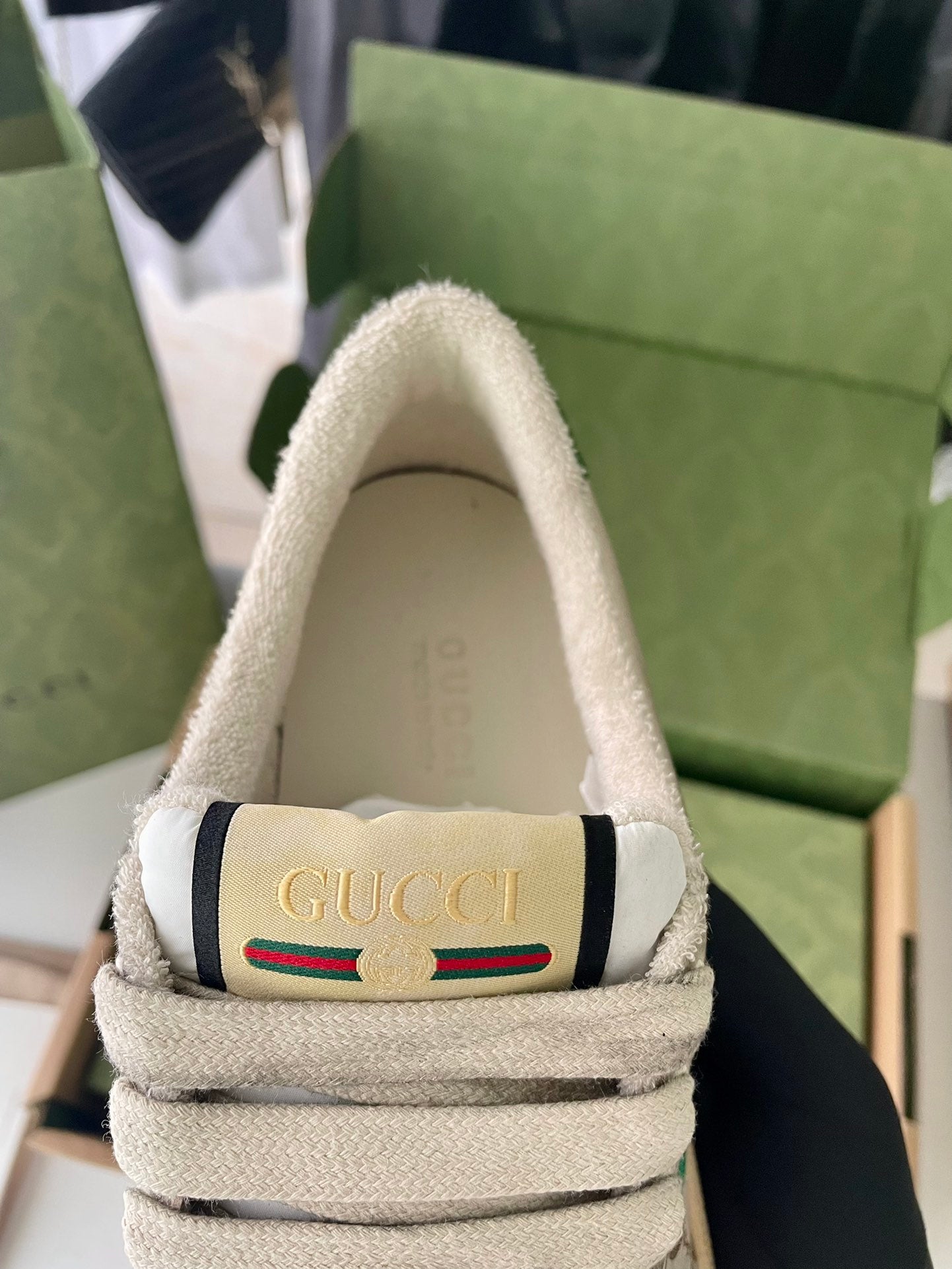 Beige sneaker inside collar with Gucci label and striped Web accent.
