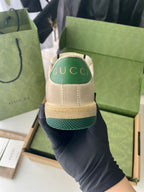 Beige sneaker heel with green textured band and cushioned collar.