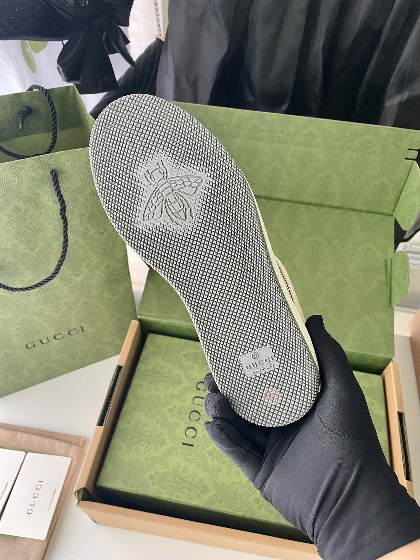 Gucci sneaker outsole with textured tread and embossed logo on footbed.