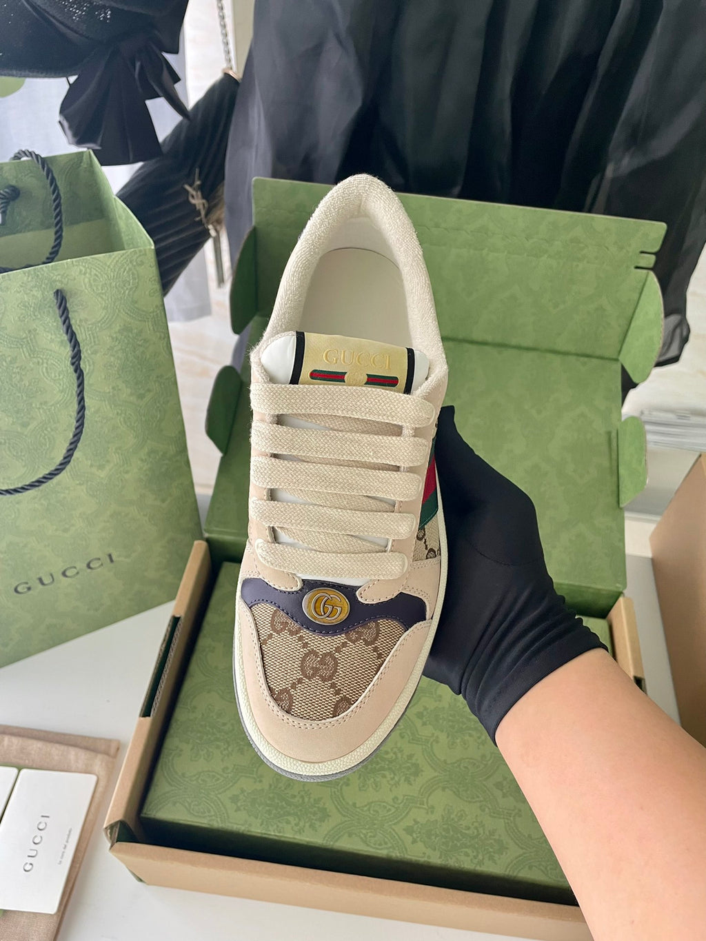Gucci sneaker with beige GG-pattern toe and Web trim, lace-up front.