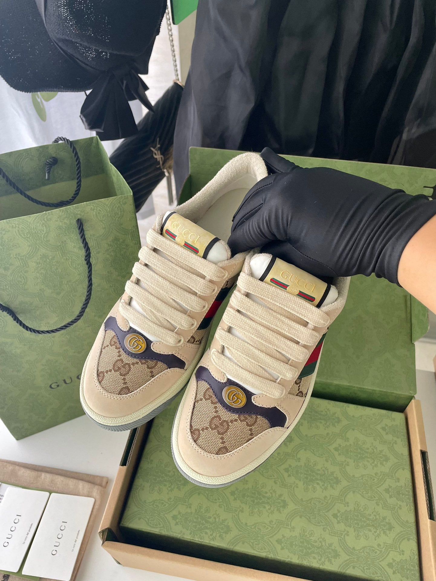 Gucci unisex sneakers pair, beige GG canvas with red/green Web accents, lace-up.