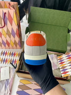 Gucci unisex sneakers back view, light gray with orange heel tab and blue sole