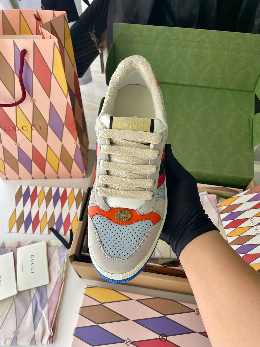 Gucci unisex sneakers heel-toe view, light gray upper with padded collar and blue sole edge