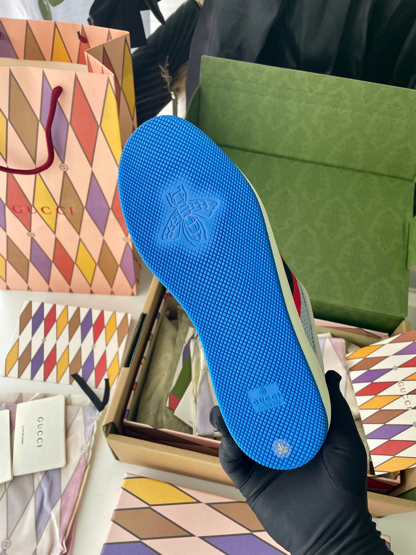 Gucci unisex sneakers outsole view, blue textured rubber sole with logo pattern