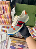 Gucci unisex sneakers with light gray upper, blue sole, red and navy stripe detail
