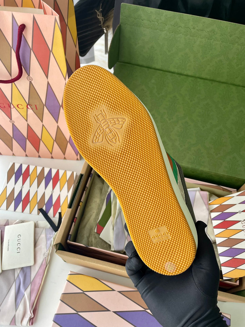 Gucci unisex sneaker outsole in yellow mesh with logo stamp pattern.
