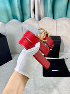 Red leather belt with gold-tone CC buckle, wide strap end with white glove