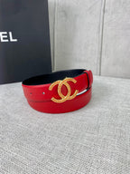 Red leather belt with gold-tone CC logo buckle, front view with curved band