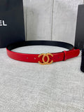 Red leather belt with gold-tone CC logo buckle and stud holes along the strap