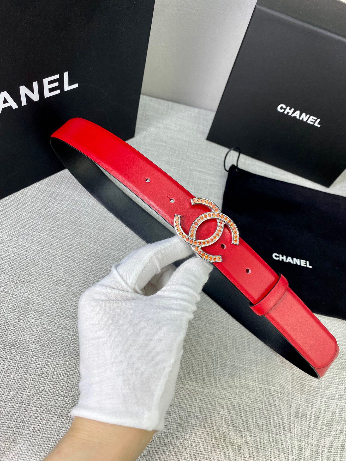 Red leather belt with gold-tone CC logo buckle, showing the length and holes