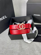 Red leather belt with gold-tone CC buckle in a box with ribbon and tissue