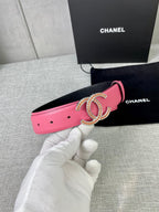 Pink leather belt with gold-tone CC buckle, strap side with punched holes