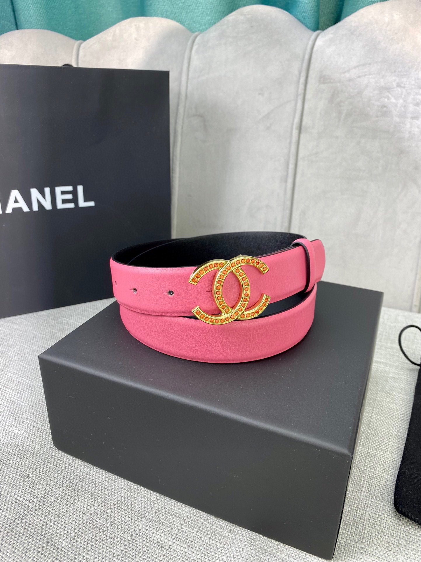 Pink leather belt with gold-tone CC buckle and studded strap on gift box