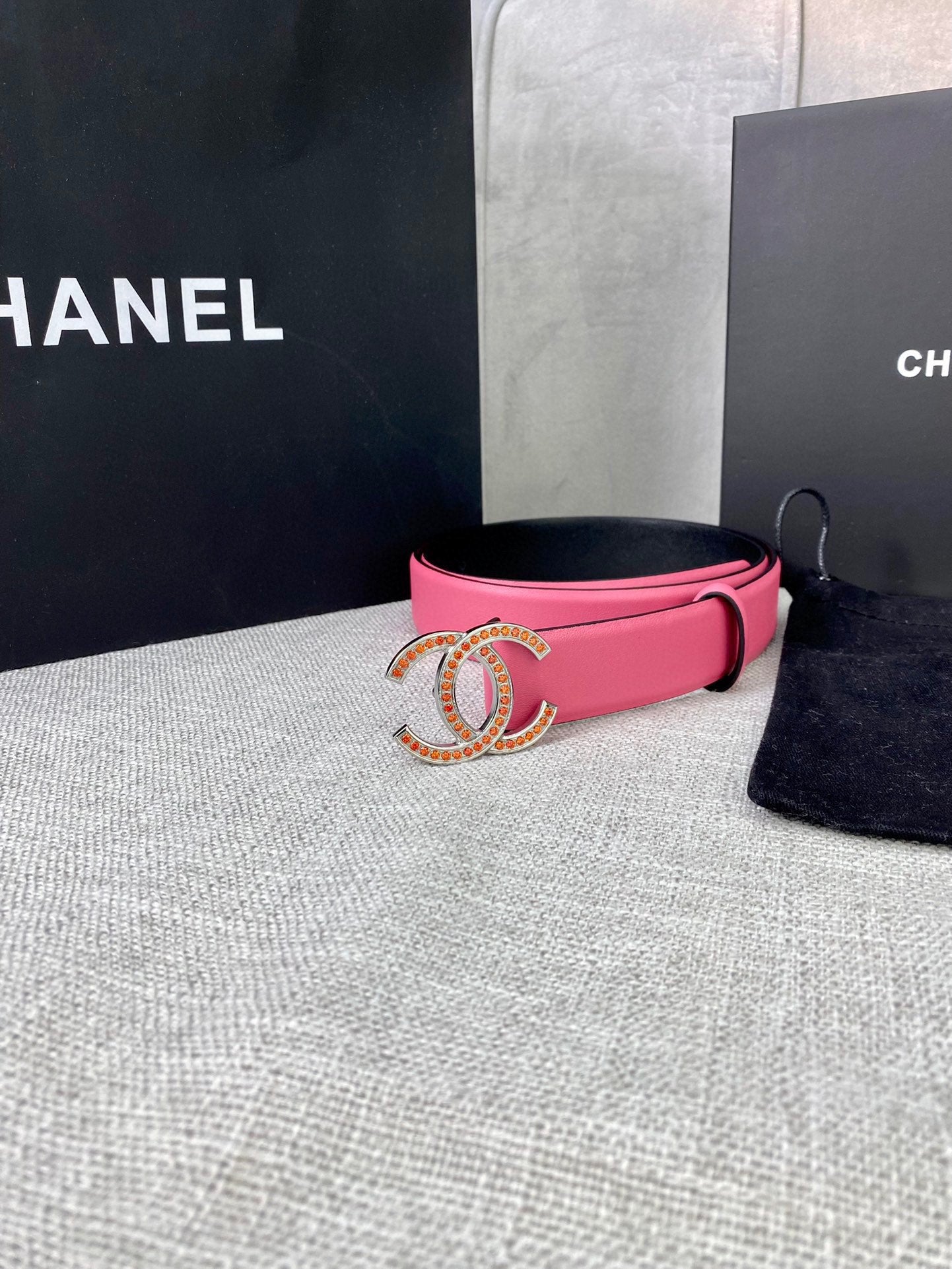 Pink leather belt with gold-tone CC buckle, side view