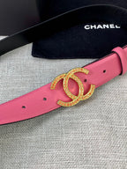 Pink leather belt with gold-tone CC logo buckle, close-up on gold hardware