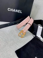 Light pink leather belt with ornate gold logo buckle, angled on display box