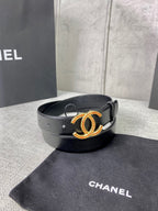 Black leather belt with jeweled CC buckle on display surface
