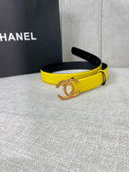 Yellow belt with gold-tone logo buckle, side view with black inner edge