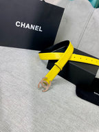 Yellow leather belt with gold-tone logo buckle, looped on display packaging