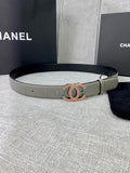 Light gray leather belt with oval CC buckle in gold and orange enamel