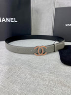 Light gray leather belt with oval CC buckle in gold and orange enamel