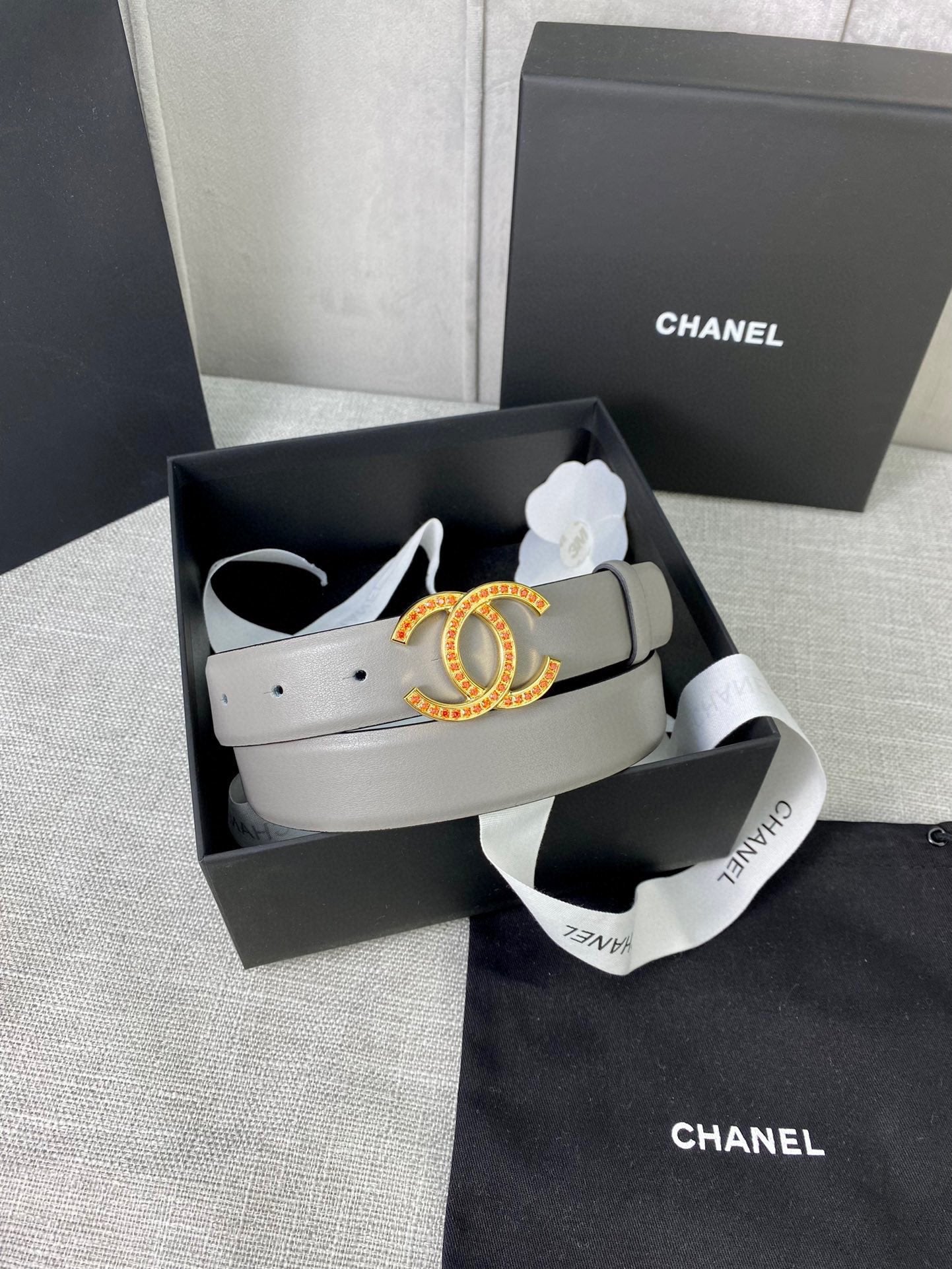 Light gray leather belt with oval CC buckle in box with dust bag and pouch