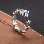 Silver-tone floral charm bracelet with open band and decorative flower ends