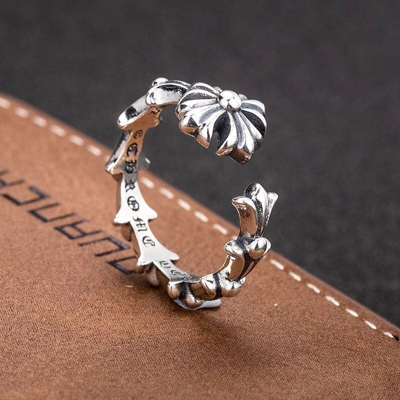 Silver-tone floral charm bracelet with open band and decorative flower ends