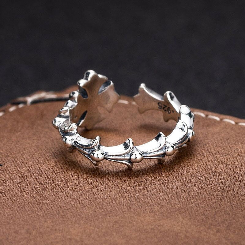 Silver-tone floral charm bracelet with ring-like band and textured flower accents