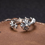 Floral charm bracelet with silver-tone open circle design and flower details