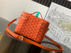 Small orange patterned handbag with strap and top handle, gold-tone hardware