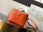 Small orange patterned crossbody bag with top handle and gold-tone zipper detail