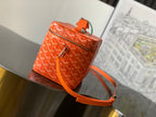 Small orange patterned crossbody bag with front zip pocket and adjustable shoulder strap