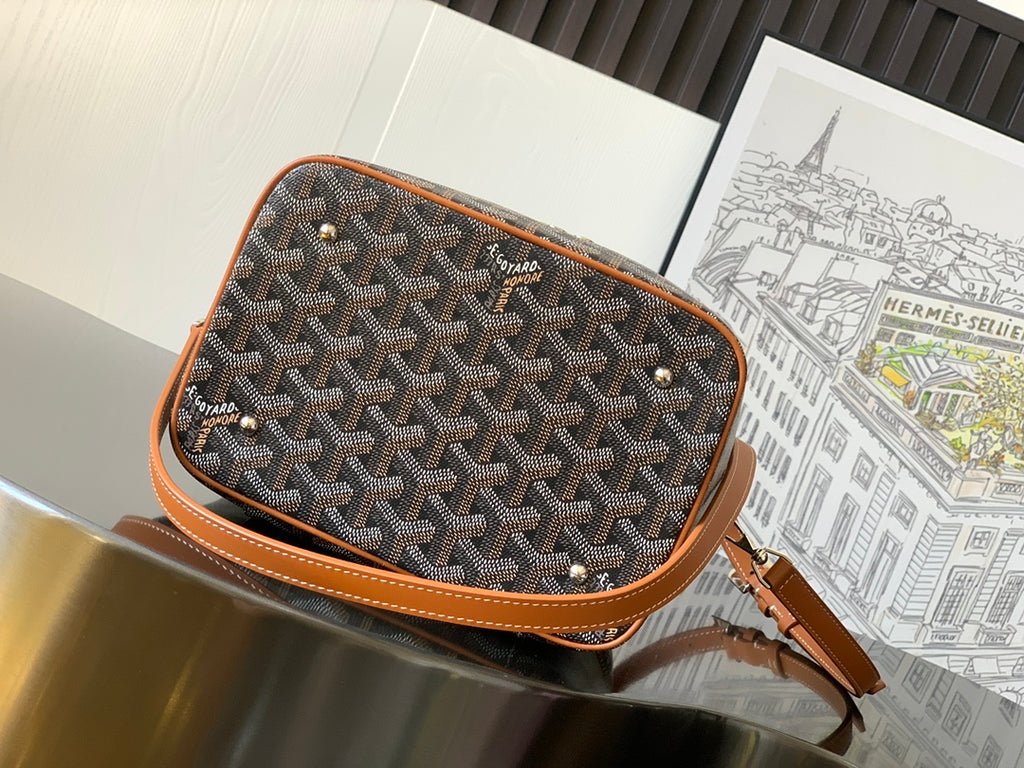 Goyard patterned canvas crossbody bag with brown trim, open top revealing dark interior