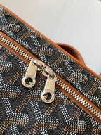 Small crossbody bag detail: silver-tone zipper pulls and metal rings on tan trim.