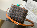 Goyard patterned canvas bag with brown leather trim and turquoise tag on top handle
