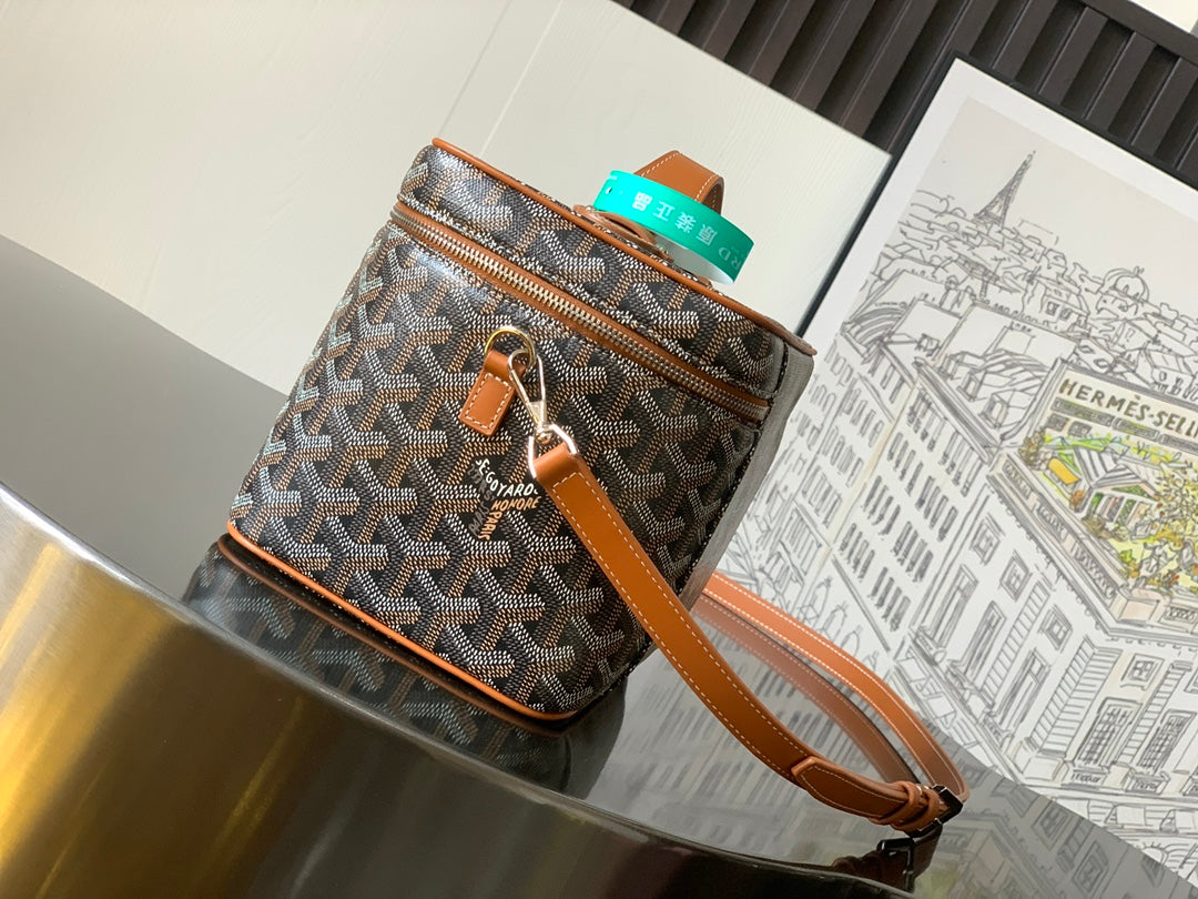 Goyard patterned canvas mini crossbody bag with front zipper, brown strap and leather trim