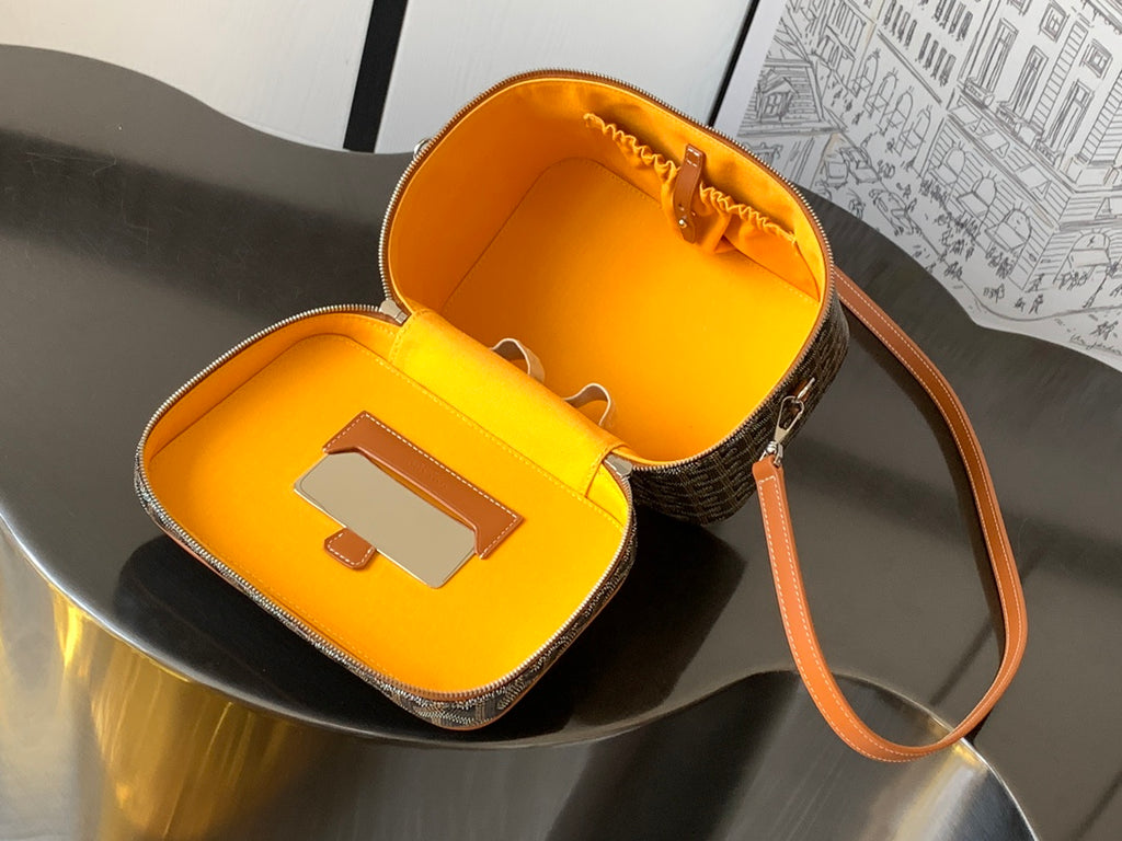 Goyard small bag with open top and bright yellow interior, brown leather strap
